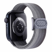 Alternate text: "Smartwatch with a blue woven loop band and black watch case with sensors visible on the back, isolated on a white background."